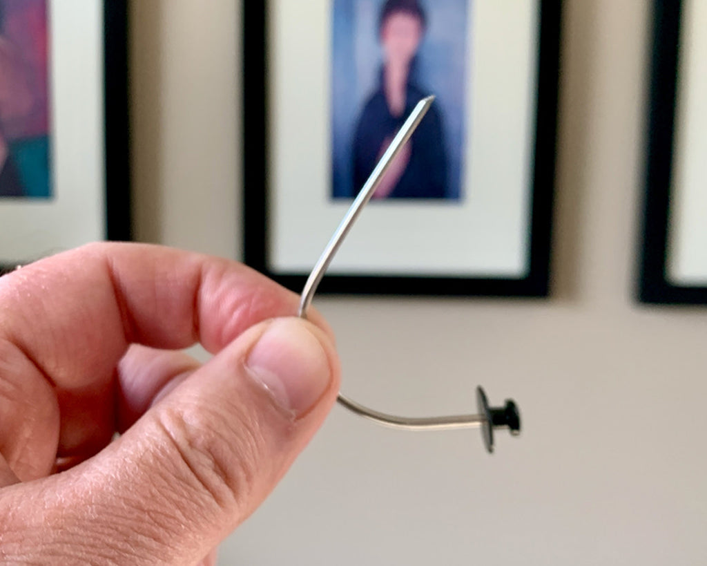 Hang pictures securely without nails or tools